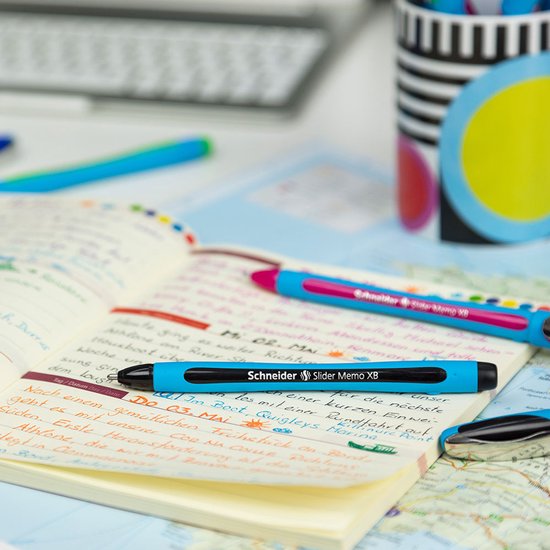 Twee Schneider Slider Memo XB pennen, blauw en roze, op een open schrift met een landkaart eronder.
