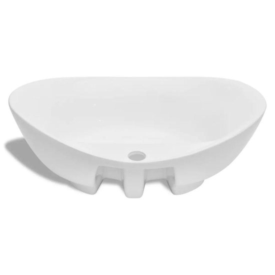Lavabo ovale en céramique blanc avec trois pieds et une vidange.