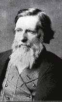 Zwart-wit portret van een man met een lange, witte baard en snor, gekleed in een jas en vest.