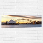 Muursticker - Zonsondergang achter de Brug in Sydney, Australië - 90x30 cm Foto op Muursticker