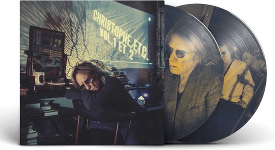 Twee picture discs van vinyl met afbeelding van man met lang haar en zonnebril, naast de hoes.
