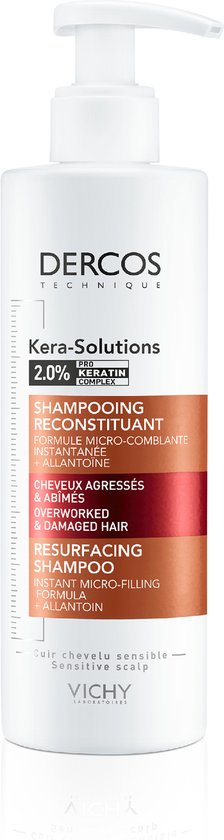 Witte fles Dercos Kera-Solutions shampoo met pompdispenser en oranje/rode label details.