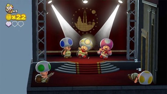 Verschillende Toads op een podium met spotlights en een rode loper.