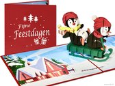 Popcards popupkaarten - Grappige Kinder Kerstkaart Lachende Pinguins op slee Wintersport Plezier Vrolijke Kerst pop-up kaart 3D wenskaart