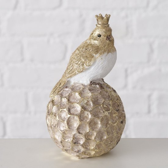 Figurine d'un oiseau avec une couronne sur une boule dorée