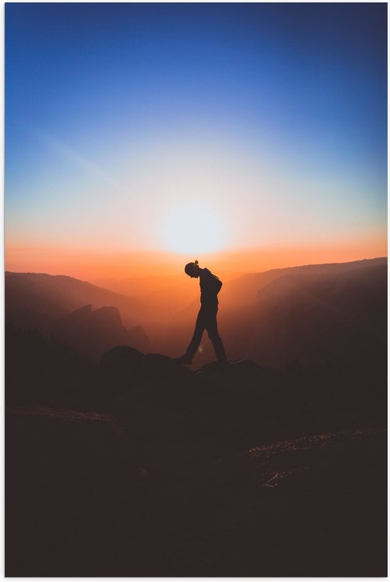 WallClassics - Poster Glanzend – Silhouet Persoon tussen de Bergen bij Zonsondergang - 60x90 cm Foto op Posterpapier met Glanzende Afwerking
