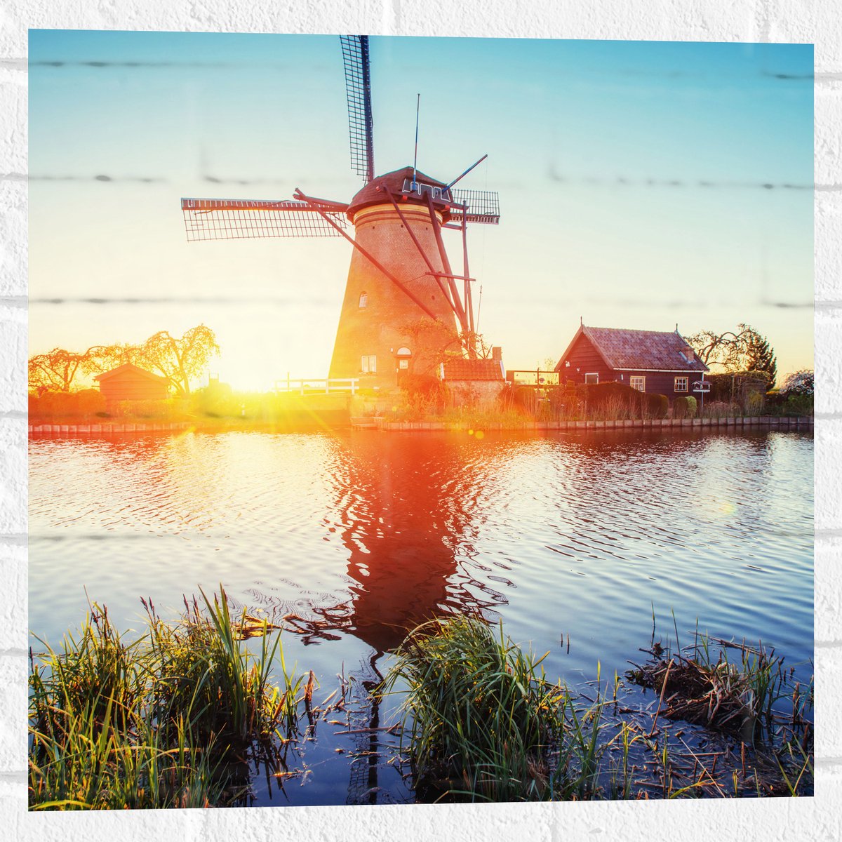 WallClassics - Muursticker - Zonlicht langs Hollandse Molen aan het Water - 50x50 cm Foto op Muursticker
