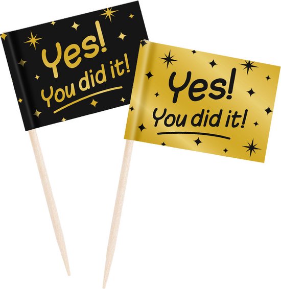Twee cocktailprikkers met vlaggetjes, zwart en goudkleurig met sterren en de tekst 'Yes! You did it!'