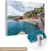 MuchoWow® Glasschilderij 90x60 cm - Schilderij acrylglas - Strand met rotsen bij Costa Brava - Foto op glas - Schilderijen