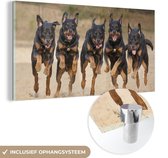 MuchoWow® Glasschilderij 120x60 cm - Schilderij acrylglas - Rennende Rottweilers op een rij - Foto op glas - Schilderijen
