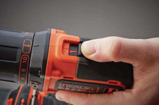 Hand die de oranje draaiknop van een BLACK+DECKER schroef-klopboormachine instelt op "1".
