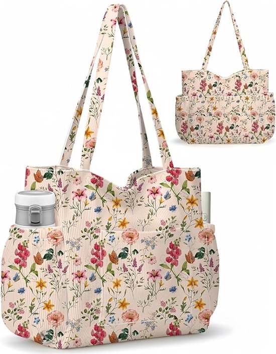 Beige tote tas met een bloemenprint van rode, roze, blauwe en gele bloemen en groene bladeren. De tas heeft aan de zijkanten buitenvakken.