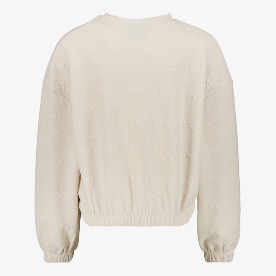 Ecru sweater met all-over textuurprint van strikjes. Elastische zoom.