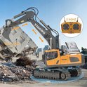 Grijze en gele RC-graafmachine die een gebouw sloopt. Inclusief afstandsbediening.