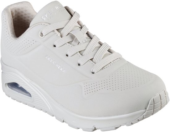 Sneaker Skechers Uno crème avec lacets, perforations sur le bout et les côtés, et amorti à air visible dans la semelle.