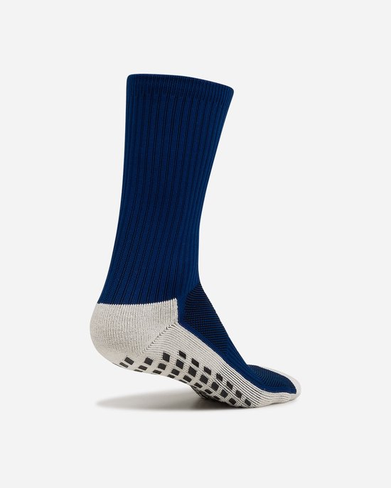 Zij-aanzicht van donkerblauwe sok met beige gripzool.