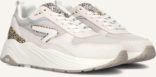 Close-up van lichtbeige HUB sneakers met luipaardprint en een witte pijl.