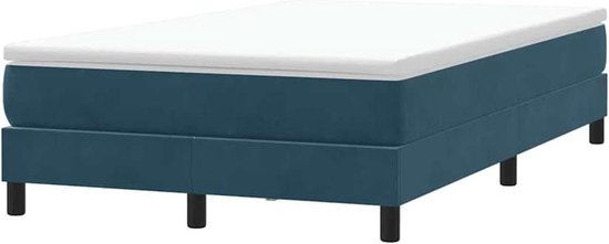 Donkerblauw gestoffeerd boxspringbed met matras en zwarte poten, gezien vanaf de zijkant.