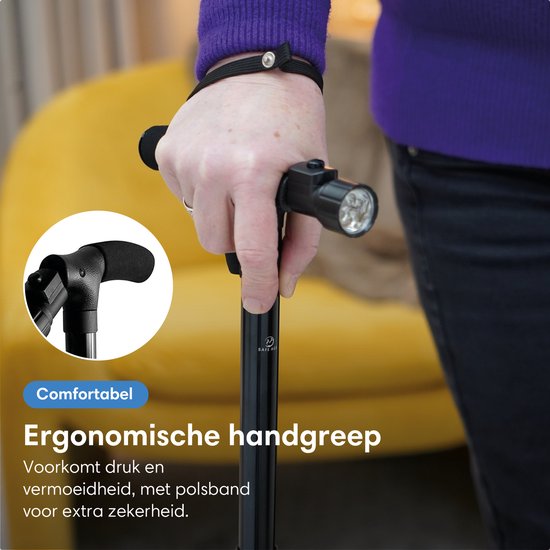 Gedetailleerde foto van een zwarte wandelstok met ergonomische handgreep en polsband.
