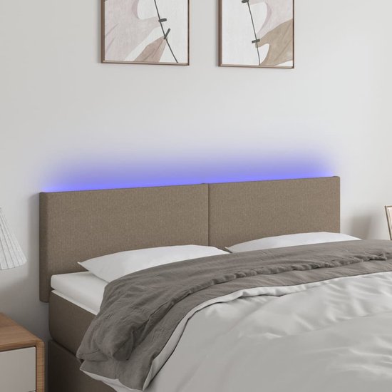 Tête de lit taupe avec éclairage LED bleu, avec deux oreillers et une couverture.