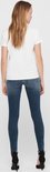 Achterkant van een model in een blauwe skinny jeans met rafels aan de zoom.