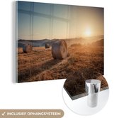 MuchoWow® Glasschilderij 120x80 cm - Schilderij acrylglas - Hooibaal - Zonsondergang - Landschap - Foto op glas - Schilderijen