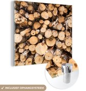 MuchoWow® Glasschilderij 50x50 cm - Schilderij acrylglas - Een stapel gekapte boomstammen - Foto op glas - Schilderijen