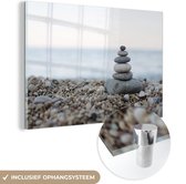 MuchoWow® Glasschilderij 90x60 cm - Schilderij acrylglas - Strand - Stenen - Grijs - Foto op glas - Schilderijen