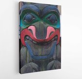 Canvas schilderij - View of ancient colorful Totem Pole with blue sky behind it in Duncan, British Columbia, Canada.  -  771740335 - 40-30 Vertical