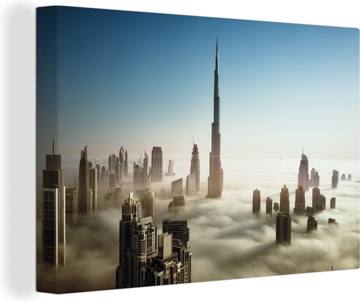 Canvas Schilderij Prachtig wolkengordijn onder de hoge wolkenkrabber Burj Khalifa - 30x20 cm - Wanddecoratie