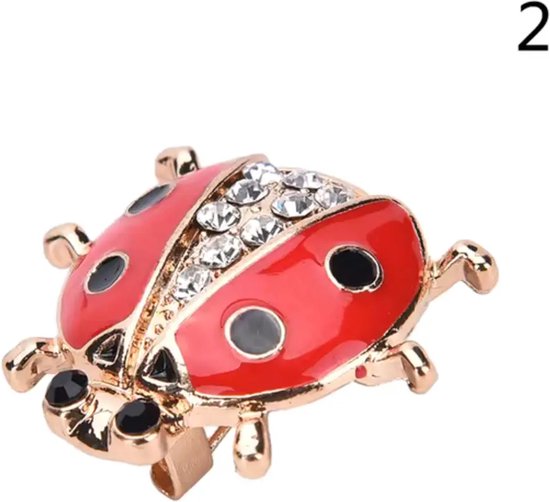 Broche coccinelle rouge à pois noirs, corps doré et cristaux sur le dos.