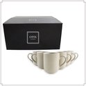 Boîte noire avec logo OTIX KITCHENWARE et un ensemble de six tasses blanc cassé à motif côtelé.