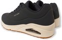 Sneaker Skechers bleu marine, vue arrière. Avec une semelle blanche, une bande de roulement marron et des coussinets d'air visibles. Logo SPERCHERS sur le côté.