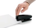 Hand op zwarte nietmachine die papier niet.