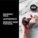 Hand met kleipomade potje, met tekst 'MAXIMALE HOLD. LICHTGEWICHT. GESCHIKT VOOR FIJN HAAR.'