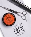 Kam, schaar en pot American Crew Matte Clay op een witte handdoek.