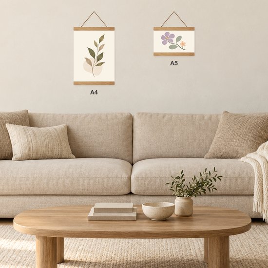 Twee posterhangers in A4- en A5-formaat aan een muur boven een beige bank.