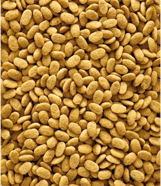 Kleine, ovale, lichtbruine pellets van Nutribird vogelvoer die een oppervlak vullen.