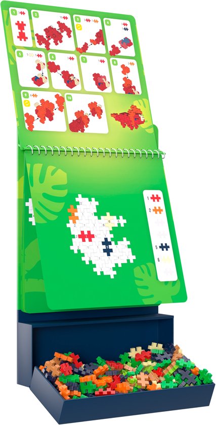 Plus Plus activiteitendrukker dino's. Openklapt met bouwinstructies en een begin van een dino-bouwsel.
