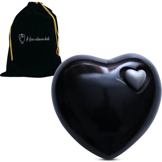Zwarte hartvormige urn met een kleiner hartje erin, naast een zwarte fluwelen zak.