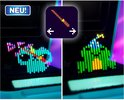 Twee Bitzee karakters, één met groene en blauwe kleuren, de ander met roze en paarse kleuren.