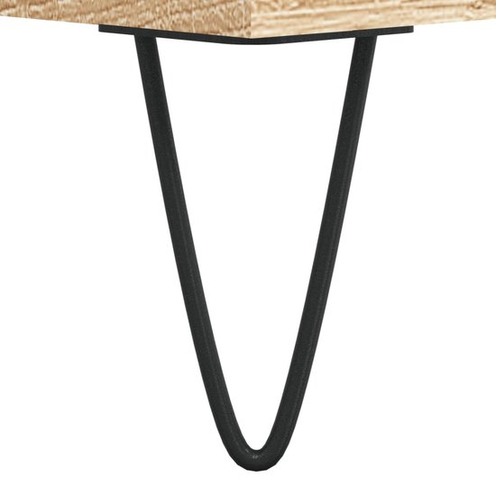 Detail van een zwart hairpin poot van een dressoir met eikenprint.