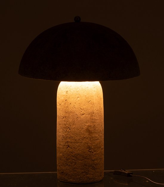 Beige papieren paddenstoellamp met een cilindrische voet, verlicht van binnenuit in het donker.