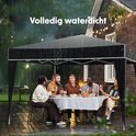 Groep mensen genietend van eten onder een zwarte partytent tijdens regen. De tekst "Volledig waterdicht" is zichtbaar.