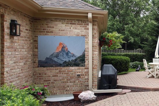 Tuinposter 120x80 cm - Tuindecoratie De Matterhorn in Zwitserland bij zonsopkomst - Poster voor in de tuin - Buiten decoratie - Schutting tuinschilderij - Tuindoek muurdecoratie - Wanddecoratie balkondoek