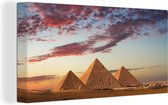 Canvas Schilderij Een zonsondergang bij de piramides van Giza - 80x40 cm - Wanddecoratie