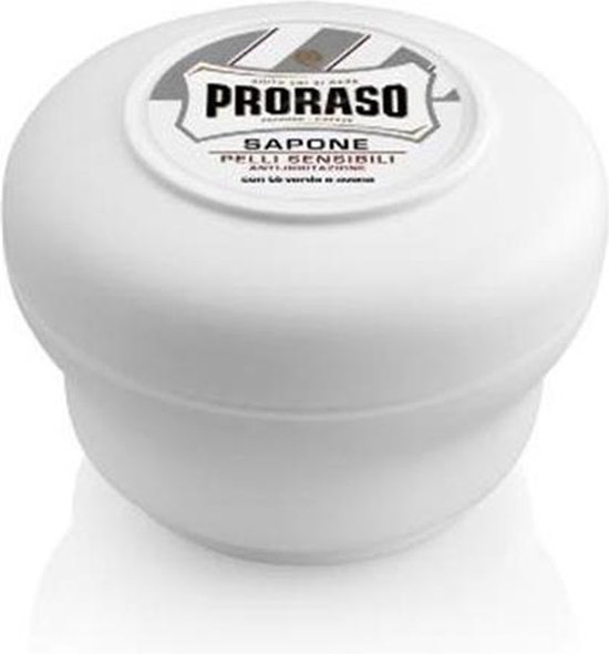 Witte Proraso scheerzeep in een kom, met groene thee en haver.