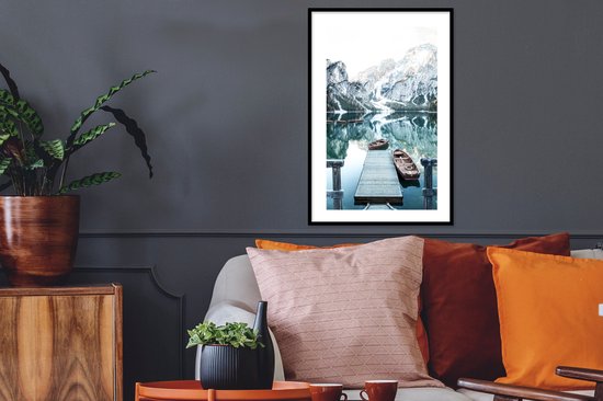 Winterlandschap met bergen, water en boten, hangend in een woonkamer.