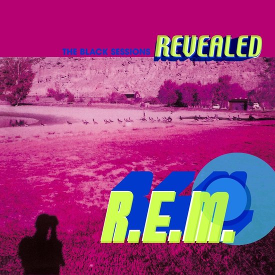 Roze albumhoes met een landschap, de tekst 'THE BLACK SESSIONS REVEALED' en 'R.E.M.' in felgeel en blauw.