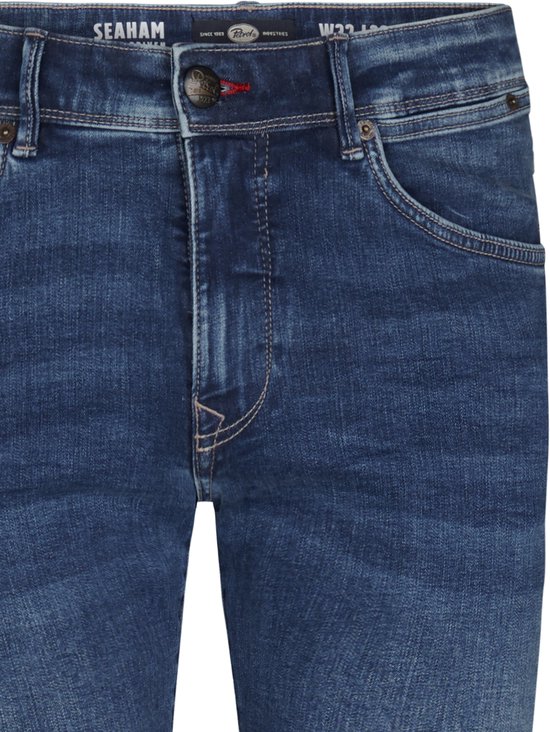 Donkerblauwe Petrol Industries Seaham jeans met knoopsluiting, riemlussen en contrasterend stiksel.
